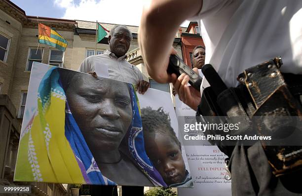Danny K. Davis, D-Ill, and Donna M. Christensen, U.S. Virgin Islands Delegate to Congress, are arrested on the steps of the Sudanese Embassy. They...