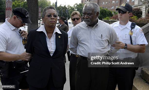 Danny K. Davis, D-Ill, and Donna M. Christensen, U.S. Virgin Islands Delegate to Congress, are arrested on the steps of the Sudanese Embassy. They...