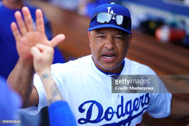 Manager Dave Roberts of the Los Angeles Dodgers high-fives after winning the MLB game against the Los Angeles Angels at Dodger Stadium on July 15,...