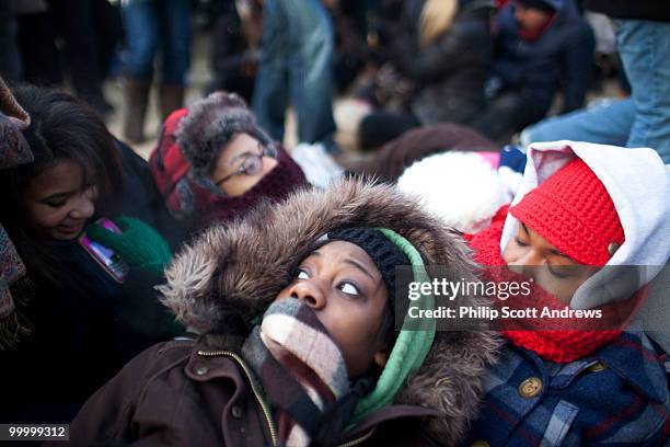 Tiffanie Davis lays with her friends from Howard University while trying to stay warm during the wait for the 56th inauguration.