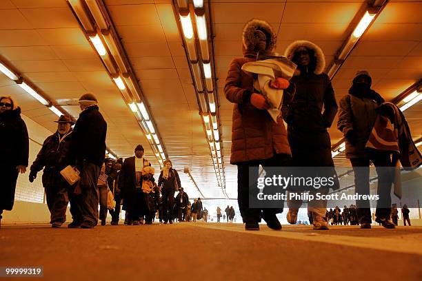 People make their way home through the I-95 tunnel after spending the day in sub-zero temperatures on the National Mall after the 56th Inauguration...