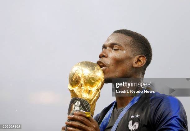 Paul Pogba of France kisses the World Cup trophy after his team defeated Croatia 4-2 to win the country's second World Cup title at Luzhniki Stadium...