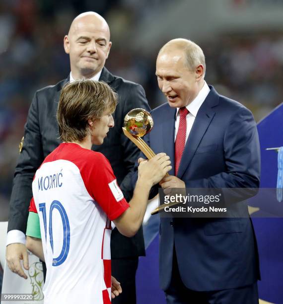 Croatia's Luka Modric receives the Golden Ball trophy for the World Cup's best player from Russian President Vladimir Putin at Luzhniki Stadium in...