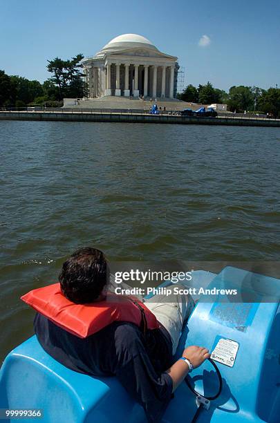 Luis Denavides paddles a paddle boat around the Jefferson Memorial tidal basin. The boats are available for rent across the basin from the memorial...