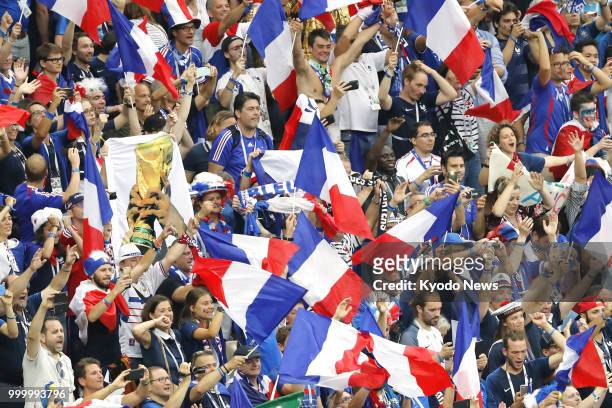 French supporters celebrate after France beat Croatia 4-2 to win the country's second World Cup title at Luzhniki Stadium in Moscow on July 15, 2018....