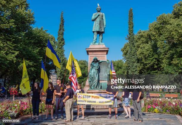 Small group of Ukrainian people stage a protest against Russia on early July 16 in the Esplanadi park in Helsinki, Finland, some hours ahead of the...