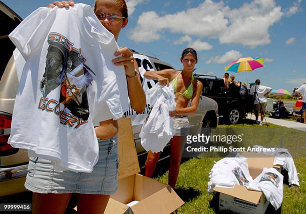 Debbie Stonecipher and her sister Diana Stonecipher sell STS-121 t-shirts for 10 dollars on the side of route 1 in Titusville, Fla. Many people are...
