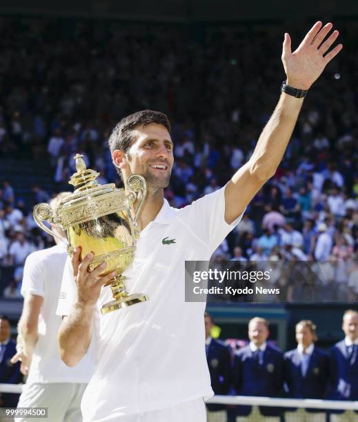 Novak Djokovic of Serbia acknowledges spectators after defeating Kevin Anderson of South Africa in the Wimbledon men's singles final in London on...