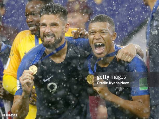 Olivier Giroud and Kylian Mbappe of France show off their medals following their victory against Croatia in the World Cup final at Luzhniki Stadium...