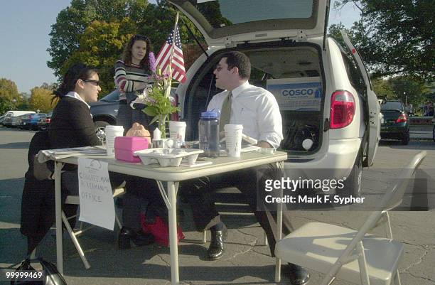 Staffers from Rep. Gary L. Ackerman's office set up outside the House Triangle on Wednesday in liew of taking a day off. From left, Amy Lee, Dana...
