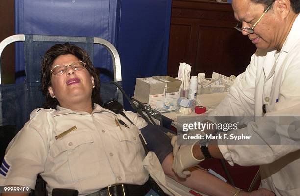 Doctor Agustin Figer Jr. Shows Sgt. Rose Cabezas that giving a little blood really isn't that bad. Although Sgt. Cabezas is a rookie blood donor, she...