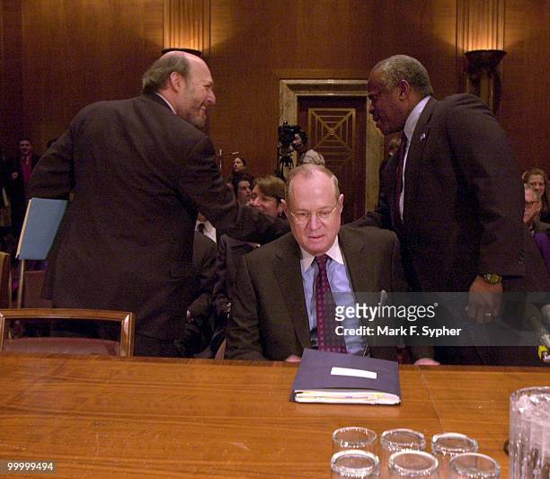 Supreme Court Associate Justice Anthony Kennedy sits down while Supreme Court Associate Justice Clarence Thomas greets the Architect of the Capitol,...