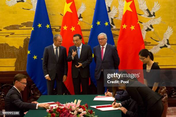 European Council President Donald Tusk, Chinese Premier Li Keqiang and European Commission President Jean-Claude Juncker look on as Chinese and...