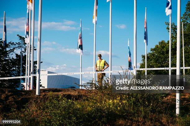 Military stands guard in front of the Finlandia Hall on the Mannerheimintie street, one of the biggest street of Helsinki, Finland on July 15 ahead...