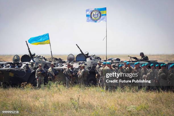 Ukrainian marines line up before their military vehicles during drills at the Shyrokyi Lan training area held as part of the Exercise Sea Breeze...