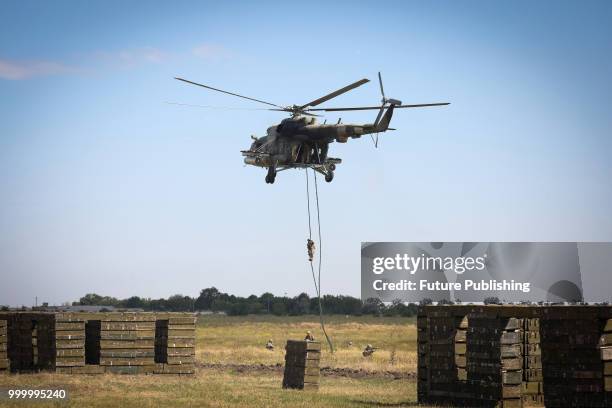 Soldier fast-ropes from a helicopter during drills of marines at the Shyrokyi Lan training area held as part of the Exercise Sea Breeze 2018,...