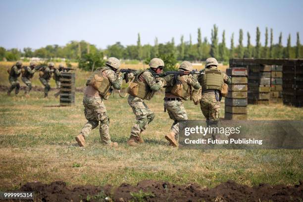 Soldiers walk in a pack during drills of marines at the Shyrokyi Lan training area held as part of the Exercise Sea Breeze 2018, Mykolaiv Region,...