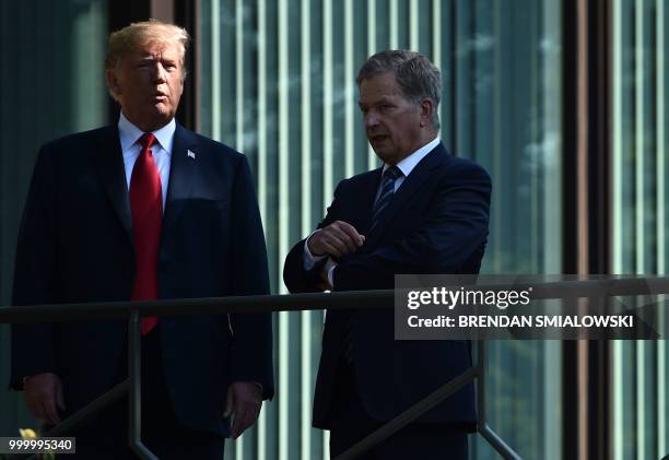 President Donald Trump and Finnish President Sauli Niinisto talk on the balcony of the Mantyniemi Presidential Residence in Helsinki, on July 16,...