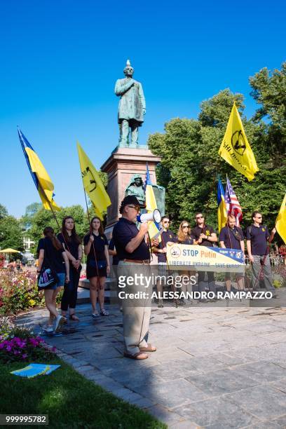 Protester holds a megaphone during a small protest of Ukrainian against Russia on early July 16 in the Esplanadi park in Helsinki, Finland, some...