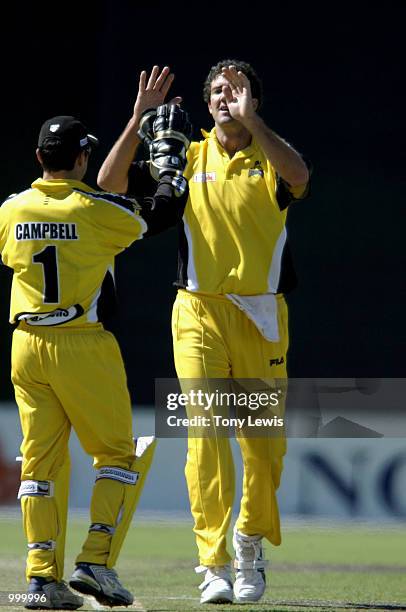 Jo Angel of West Australia celebrates with keeper Ryan Campbell after he bowled Chris Davies for 40 in the ING Cup day-night match between Western...