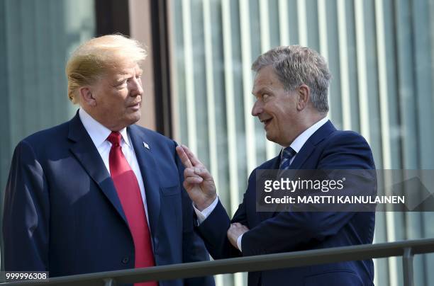President Donald Trump and Finnish President Sauli Niinisto talk as they pose at the Mantyniemi Presidential Residence in Helsinki, on July 16, 2018...