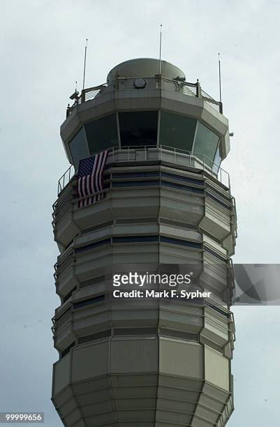 Air traffic control tower at Regan National Airport, draped with American flag.
