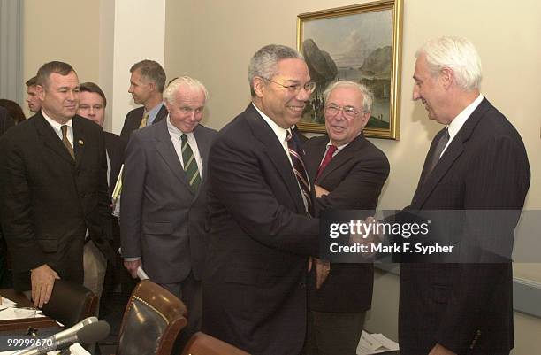 Secretary of State, Colin Powell, shakes hands with Rep. John Cooksey, R-La., as he enters the U.S. Capitol to give congress information on recent...