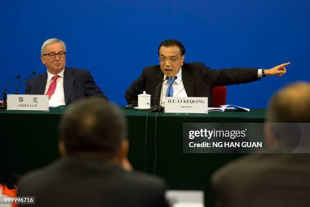 China's Premier Li Keqiang gestures asking for Chinese officials to look into problems brought up by European businessmen, as European Commission...