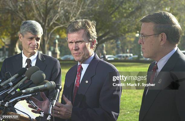 Senate Minority Leader, Thomas Daschle spoke on Thursday along with former Treasury Secretary Robert Rubin, left, and Senator Byron Dorgen , right....