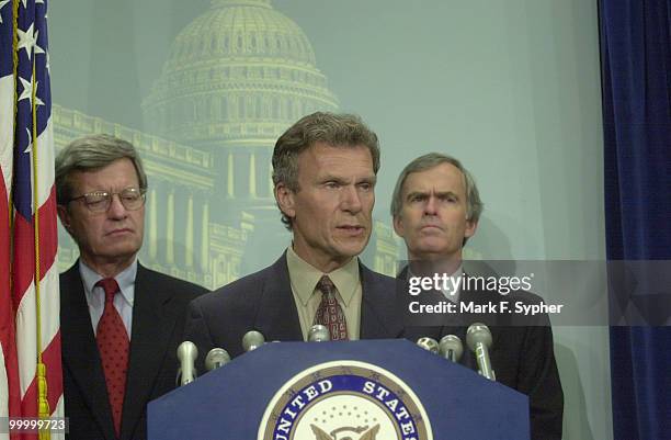 Sen. Thomas A. Daschle , address the media at a press conference concerning trade authority. Accompanying him are Senators Max S. Baucus , and Jeff...