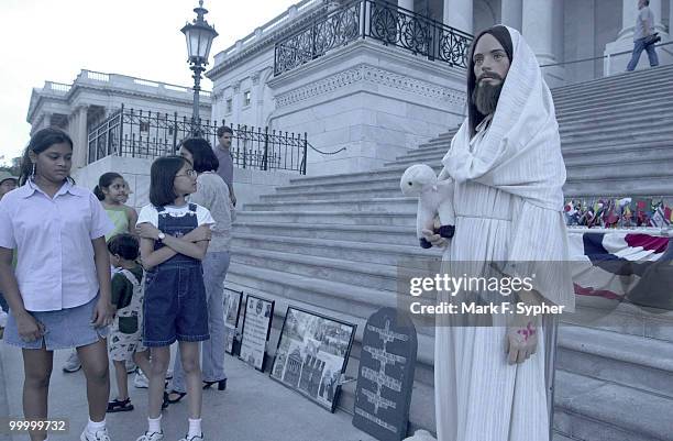 From left, Hetashree Jangla of Atlanta, GA., and Sneha Shah of Raleigh, N.C., are surprised to see Jesus on the back steps of the Capital. The shrine...