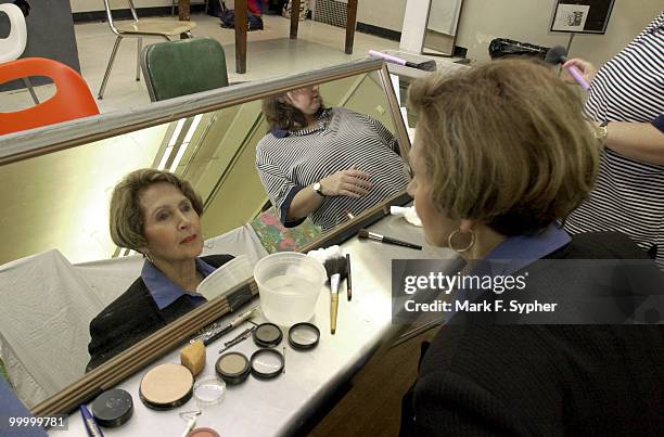 Rep. Constance A. Morella gets a little help with make-up from Cathy Dunn moments before Morella takes to the stage for Hexagon's Congress night on...