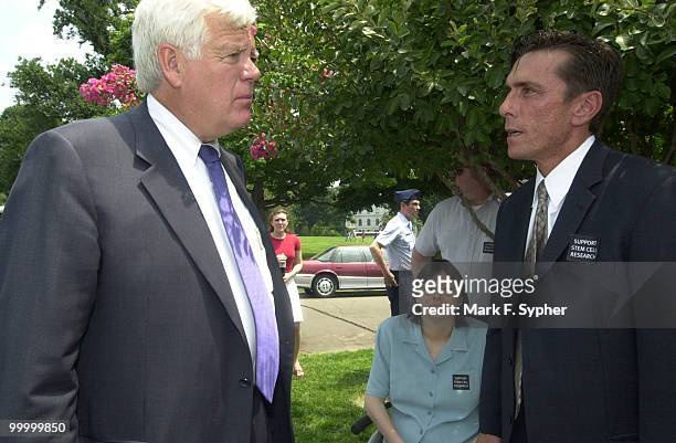 Rep. Jim McDermott , left, discussess stem cell research funding with Michael Manganiello, right, Senior Vice President of the Christopher Reeve...