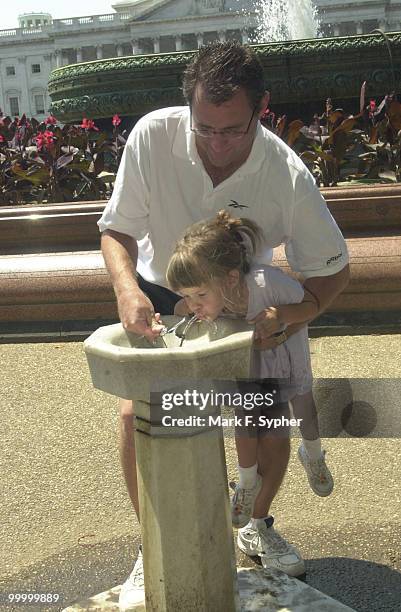 Amanda Snell of Shawnee, Kansas, gets a boost from her father Dan, on a sweltering, sultry Tuesday in August.