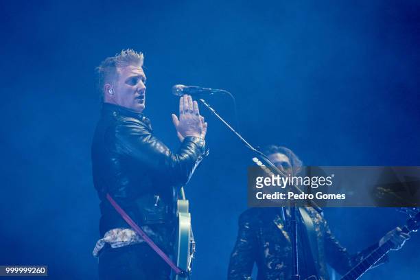 Josh Homme and Michael Shuman of Queens of the Stone Age perform on the NOS stage on day 2 of NOS Alive festival on July 13, 2018 in Lisbon, Portugal.