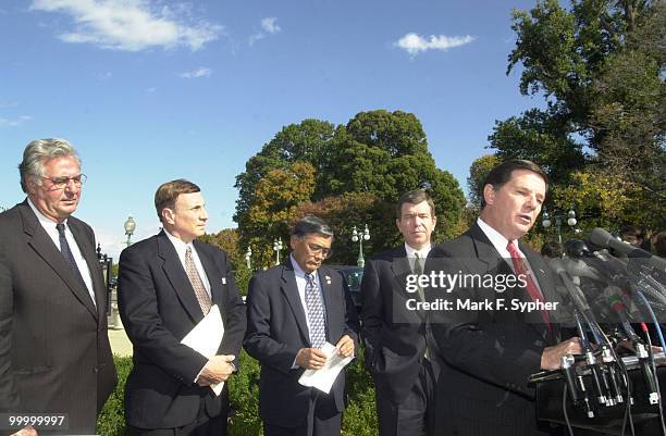 Majority Whip Tom DeLay addresses the press at the House Triangle on Thursday. Accompanying him are House Majority Leader, Dick Armey , Rep. John L....