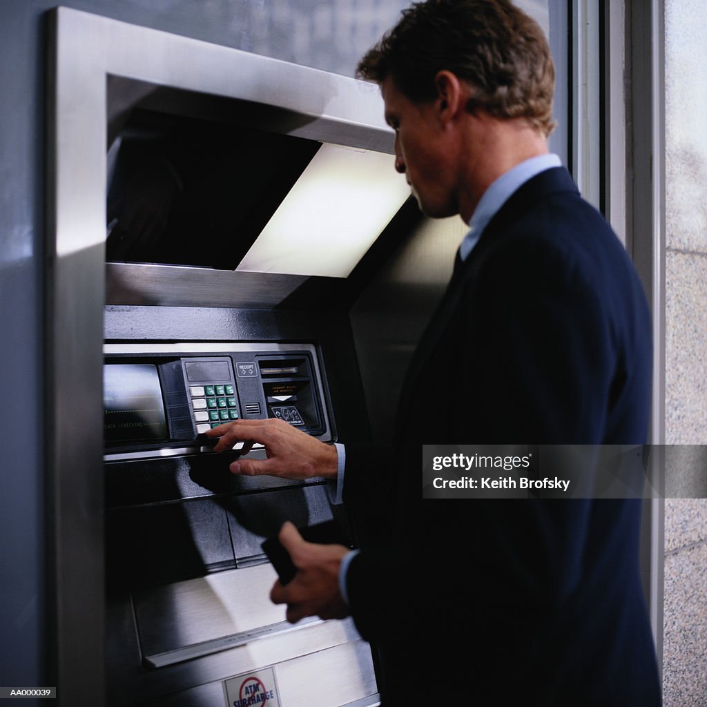 Businessman Using a Cash Machine