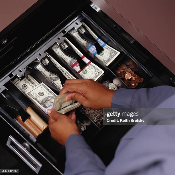 american money in a cash register till - black woman on cash register stock-fotos und bilder