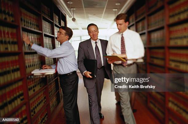 lawyers in a law library - law library stock pictures, royalty-free photos & images