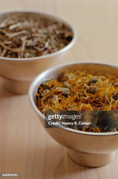 bowls of calendula and st. john's wort - calendula stock pictures, royalty-free photos & images