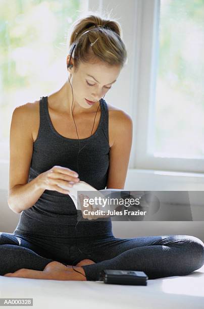 woman reading and listening to a portable radio - portable radio stock pictures, royalty-free photos & images