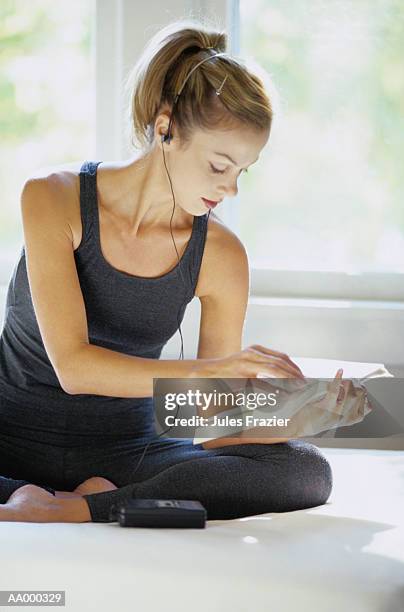 woman reading and listening to a portable radio - portable radio stock pictures, royalty-free photos & images