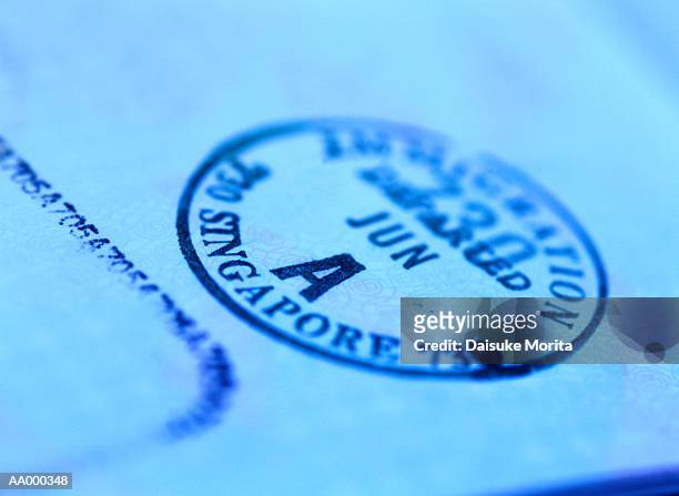 stamp issued by singapore on a passport - stamp foto e immagini stock