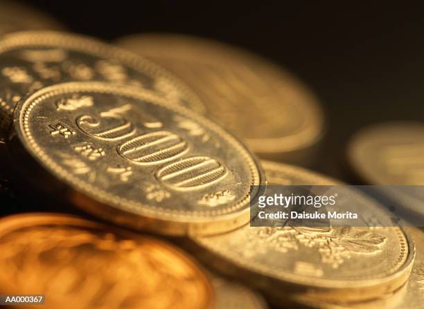 pile of 500 yen coins - 500 yen coin stock pictures, royalty-free photos & images