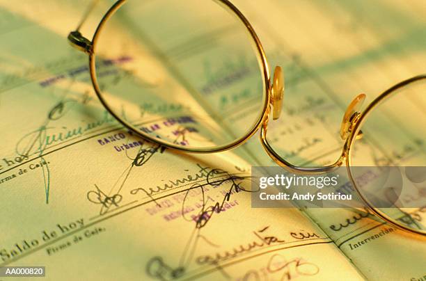 glasses resting on an old spanish bank ledger - the ledger family and australians in films 6th anniversary of the scholarship and the legacy of heath ledger stockfoto's en -beelden