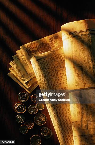 international money beside the financial page - spring meetings of the international monetary fund and world bank stockfoto's en -beelden
