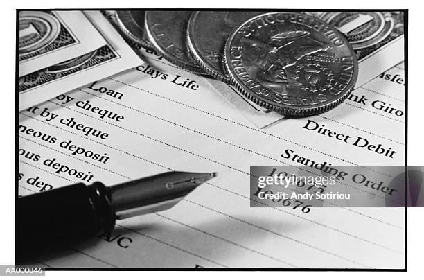 fountain pen and money on a bank statement - coin fountain stock pictures, royalty-free photos & images