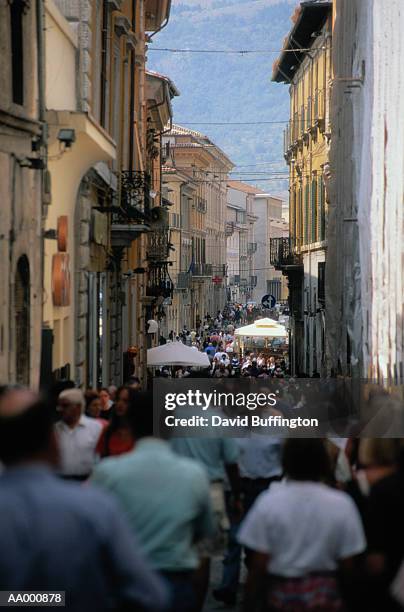 people walking on a crowded street in l'aquila - laquila photos et images de collection