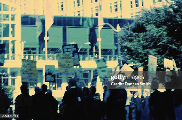 crowd carrying protest signs - picket line stock pictures, royalty-free photos & images