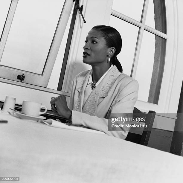 businesswoman at a table with coffee - monica askew stock pictures, royalty-free photos & images